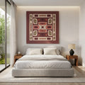 Terracotta geometric wall art displayed above a bed in a modern minimalist bedroom