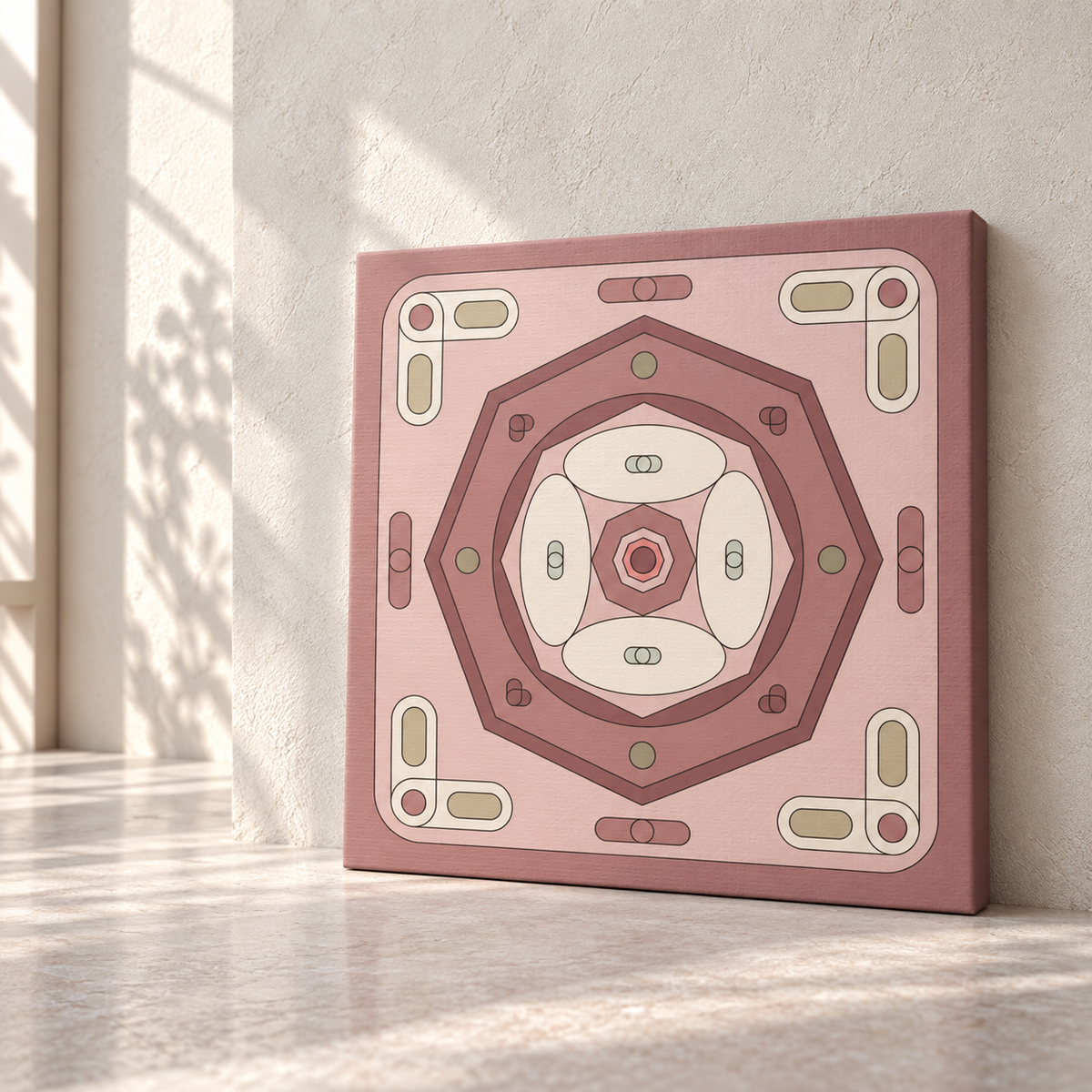 A square canvas wall art print featuring a layered geometric octagon design in dusty pink, rose, and cream tones, leaning against a light wall on a sunlit floor.