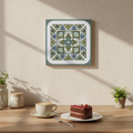 Decorative wall art piece on a wall above a wooden table with a cup of coffee and a slice of cake.